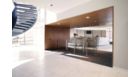 Application picture of CorePro LED PL-C. Entrance of an office and reception desk. With guy in a suit sitting behind his desk. Entrance gate for employees