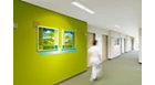 CoreLine surface-mounted luminaire in use in a corridor of a green and white corridor