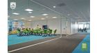 Classroom space in a learning park with green chairs and glass windows and doors