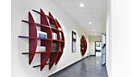CoreLine downlight in use in a corridor with red bookshelves
