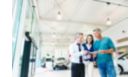 MASTERColour CDM MW eco at  car dealership with 3 people discussing something in a brochure