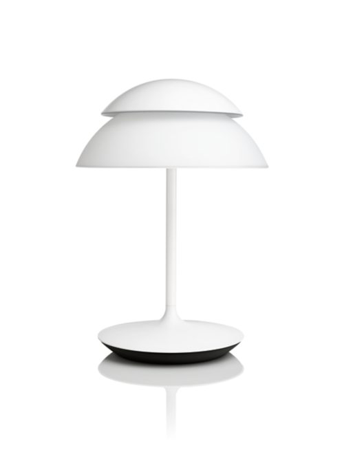 White table lamp with dome-shaped shade, round base, and slim stem, featuring a matte finish and compact design.