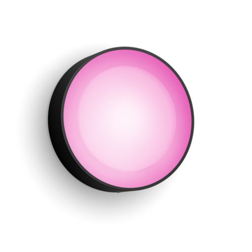 Round Daylo wall light with a black exterior and matte finish, emitting pink light from a smooth, compact circular surface.