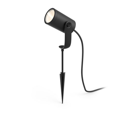 Black outdoor spotlight with cylindrical shape, matte finish, ground spike, adjustable bracket, and attached power cable visible.