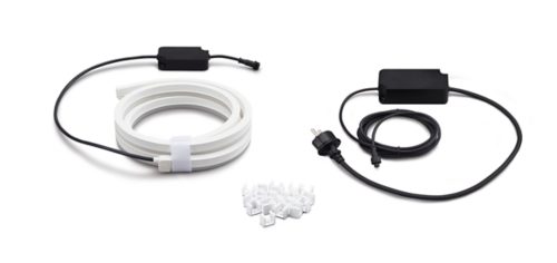 Coiled white light strip, two black power adapters with cables, and a collection of white mounting clips on a white background.