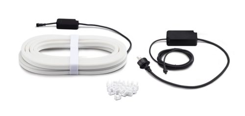 Coiled white light strip, two black power adapters with cables, and a collection of white mounting clips on a plain background.