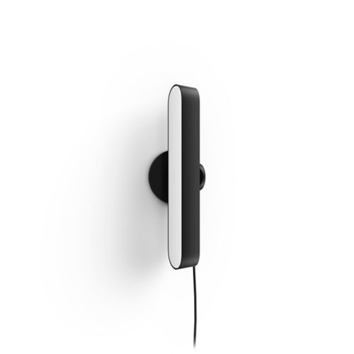 Black and white compact light bar with a matte finish, mounted vertically on a wall, visible power cord extending downward.