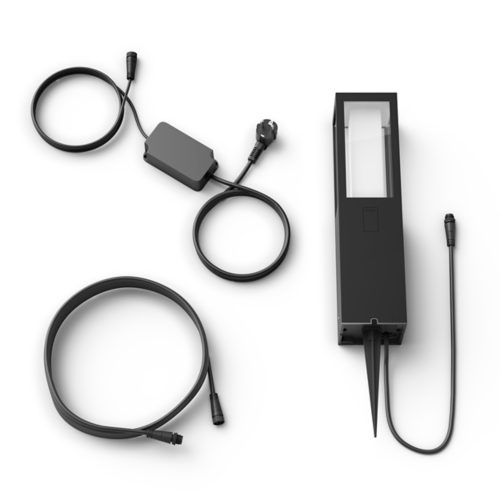 Rectangular outdoor smart light in black with matte finish, visible spike base, transparent panel, and attached cables with connectors.