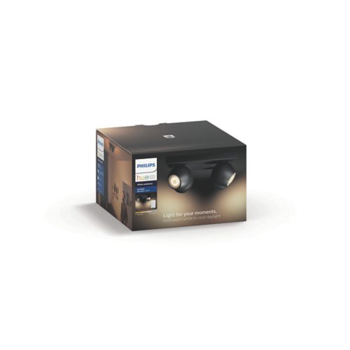 Product packaging featuring a compact black spotlight fixture with a matte finish and visible adjustable lamp heads. Text: Light for your moments, from warm white to cool daylight.