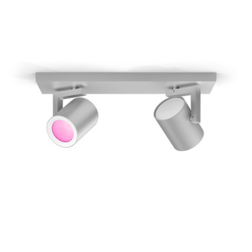 Aluminium spiral plate spotlight fixture with two cylindrical adjustable heads, one emitting pink light, matte silver finish.