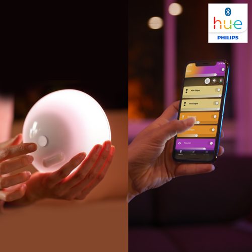 Hands adjusting a round smart light and tapping a mobile app to control lighting settings. Hue Signe and Flourish visible on screen.