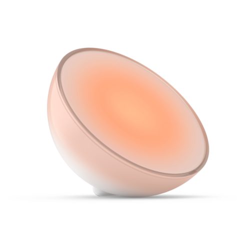 Smart portable table lamp in a rounded shape, displaying a warm orange light, with a matte finish and compact design.