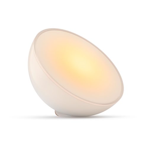 Compact round smart table lamp with a matte white finish, emitting warm light, featuring a smooth surface and no visible switches.