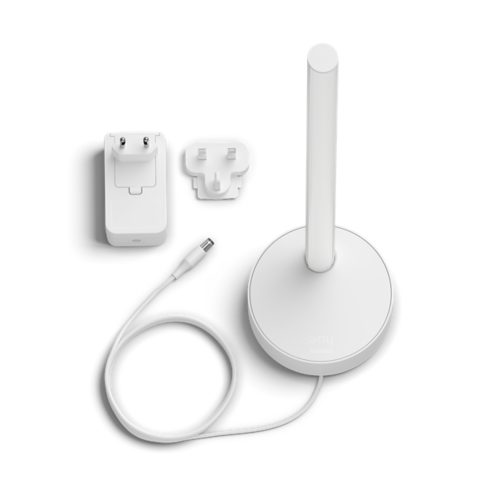 A white smart table lamp with cylindrical design, power adapter, plug attachment, and connected cable on a plain background.