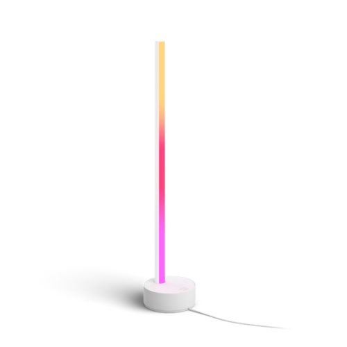 White Gradient Signe table lamp, vertical bar shape with a matte finish, displaying multicolor light, round base, visible power cord.