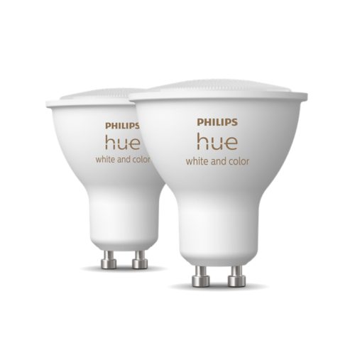 Two compact GU10-shaped white smart bulbs with metallic bases, matte finish, and white and color text visible on each bulb.