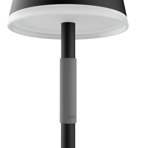Close-up of the underside of a lamp with a matte black stem, a smooth gray grip featuring hue text, and a white diffuser.