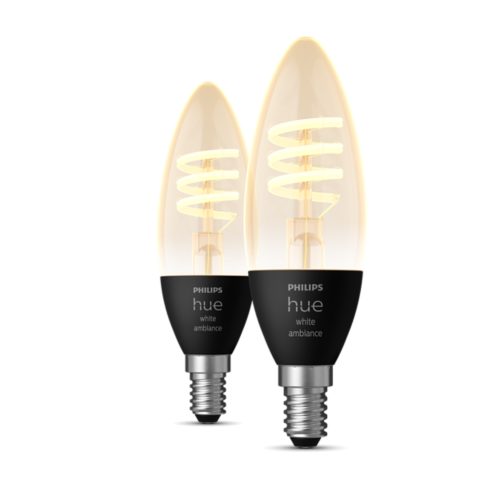 A set of smart candle-shaped LED bulbs with spiral filaments and black bases, displaying the text hue white ambiance.