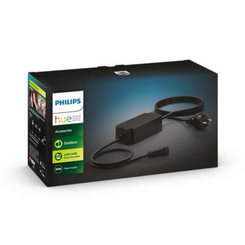 Rectangular black power supply with a matte finish, attached cable, plug, and connector, shown on product packaging with text.
