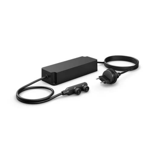 Rectangular black power supply unit with attached Swiss plug and dual port connector, featuring a matte finish and compact design.