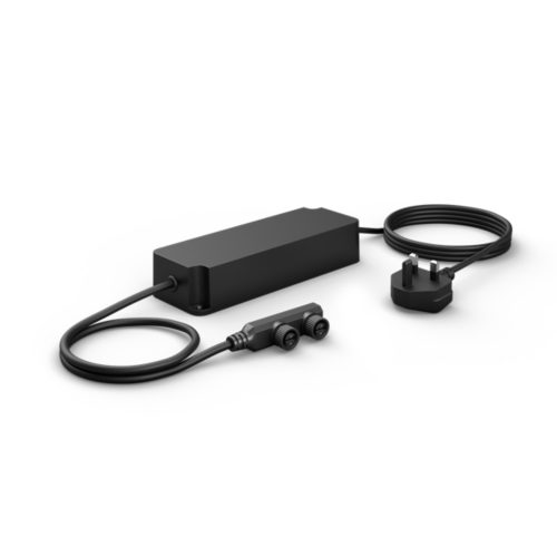 Black rectangular power supply unit with matte finish, UK plug, and dual output connectors attached by cables, compact design.