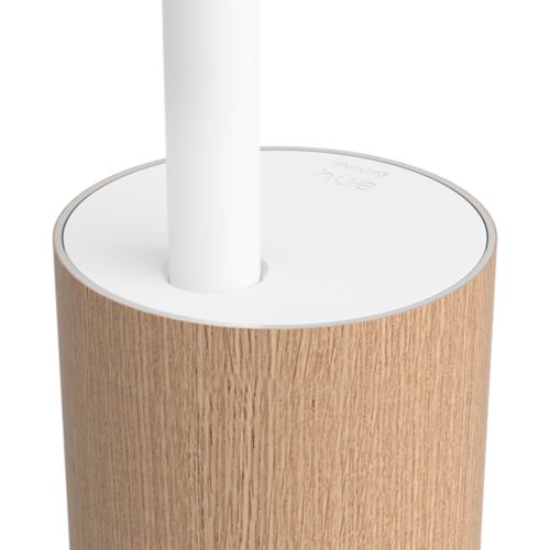 Close-up of a smart floor lamp base featuring a wood-textured cylindrical body and a smooth white top with embossed text.
