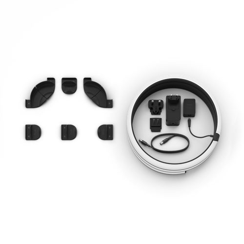 A coiled lightstrip, a collection of black mounting brackets, power adapter, plug adapters, and a cable arranged on a white surface.