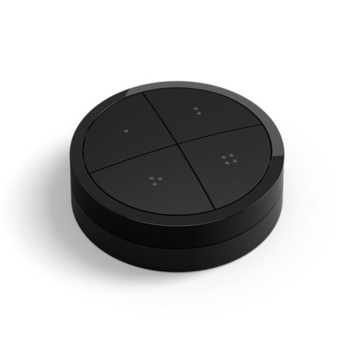 Black Philips Hue Tap dial switch, round shape, matte finish, featuring four distinct buttons with small raised dots.
