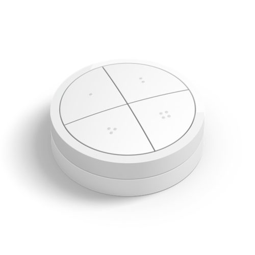 White Tap dial switch, round shape, matte finish, featuring four distinct buttons with small circular indentations. Compact design.