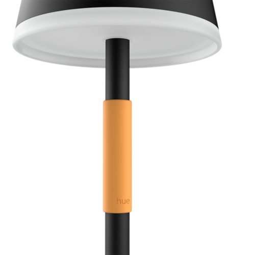 Close-up of a portable lamp stem with a matte black finish and an orange textured grip featuring the word hue embossed.