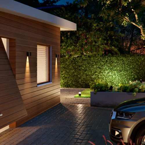 Outdoor downward wall lights mounted on wooden exterior, illuminating the wall and pathway near a window and driveway.