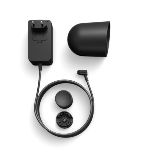 Black wired security camera housing, power adapter with cable, mounting base, and circular accessory displayed on white background.
