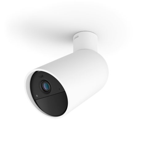 White cylindrical smart security camera with matte finish, black front panel, lens, and visible mounting bracket on the ceiling.
