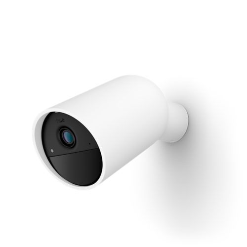 White cylindrical battery-powered security camera with matte finish, black front panel, and visible lens mounted on a wall.