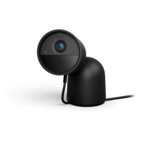 Black round wired security camera with compact matte finish, desktop stand, lens, indicator lights, and visible cable connection.
