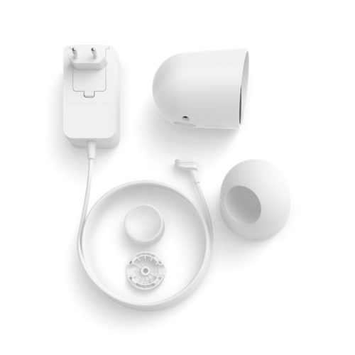 Collection of white components including a wired security camera, power adapter, cable, desktop stand, and mounting accessories.