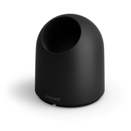 Black desktop stand accessory with a rounded dome shape and matte finish, featuring an open slot and visible Philips text.