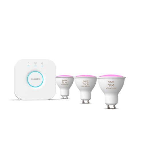 A set of smart lighting products including a hub and several white smart bulbs with pink tops, all sharing a similar design.