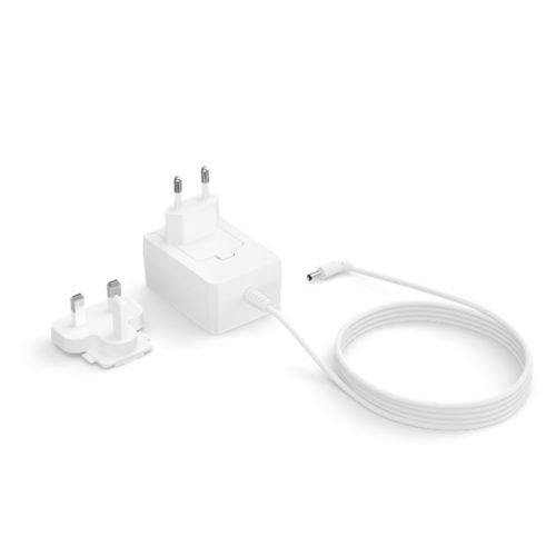 White power adapter with attached cable, interchangeable plug components for EU and UK sockets placed on a plain background.