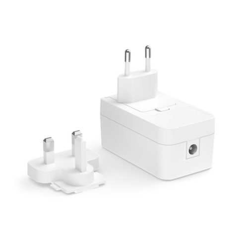 White compact power adapter with a rectangular shape, EU plug attached, UK plug adapter beside, and a visible DC port on the side.