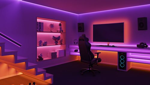 Gaming room with shelves, desk, and stairs illuminated by purple and orange smart LED light strips creating soft ambient glow.
