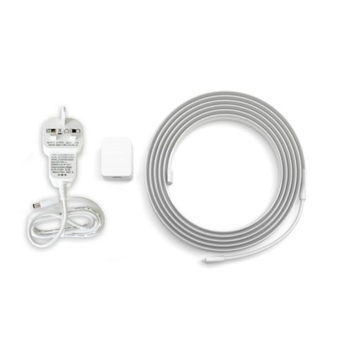 A coiled lightstrip, a white power adapter with UK plug, and a small rectangular control unit with Hue text are shown.