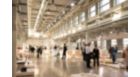 MASTERColour CDM MW eco at  an art exhibition, industrial building. Groups of people everywhere looking at the art pieces. Big industrial luminaires